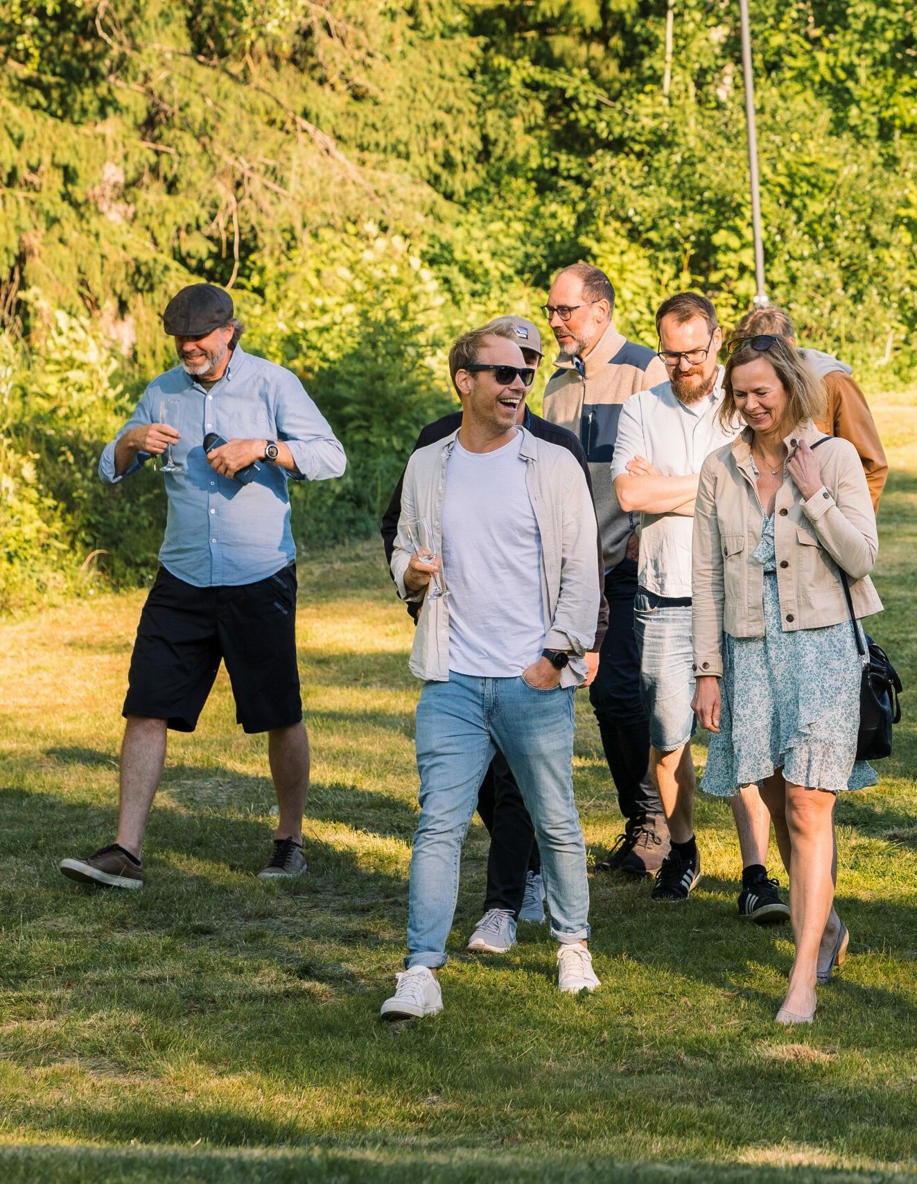 Några kollegor går på gräset och skrattar